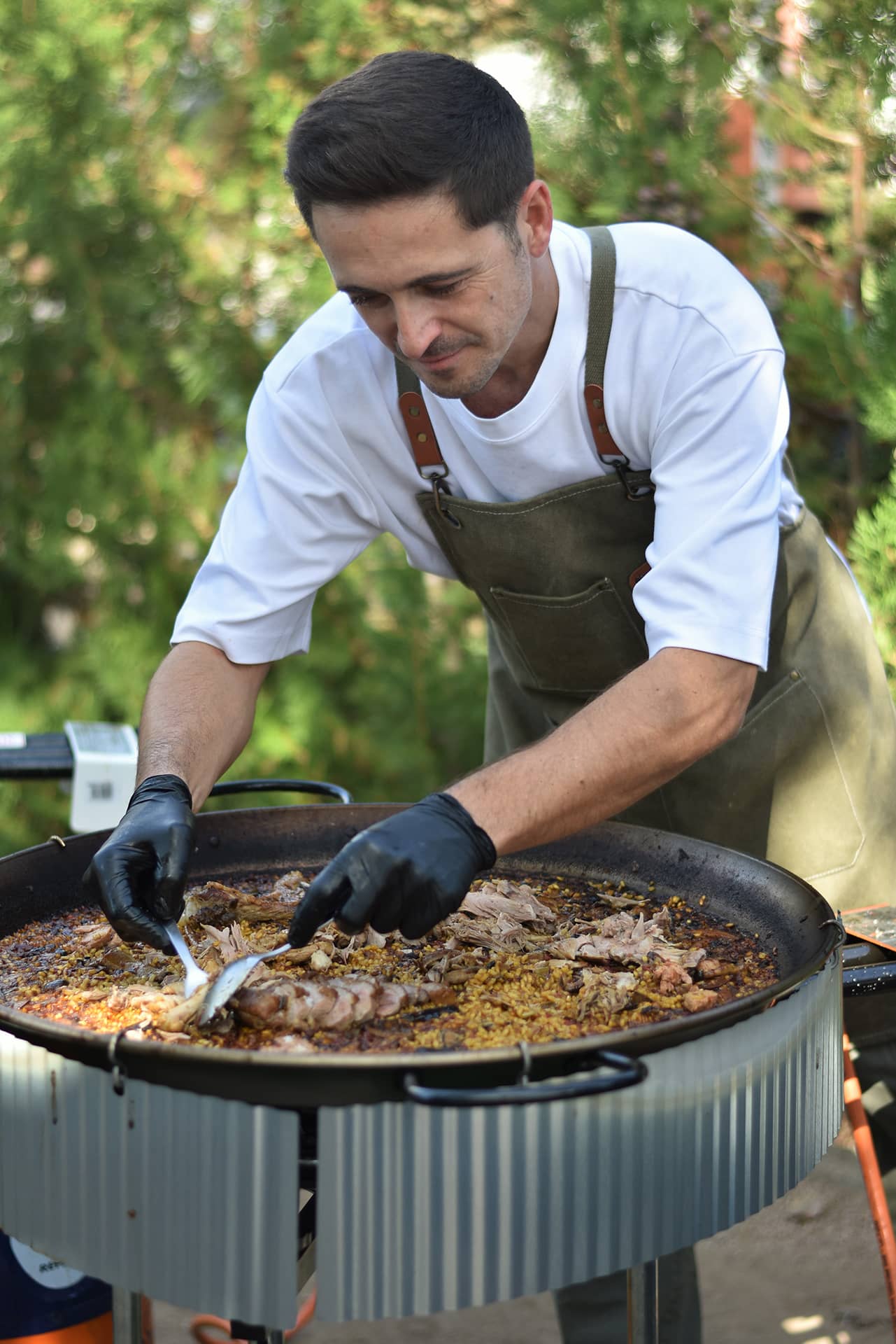 Chef preparing paella at Lake Orellana